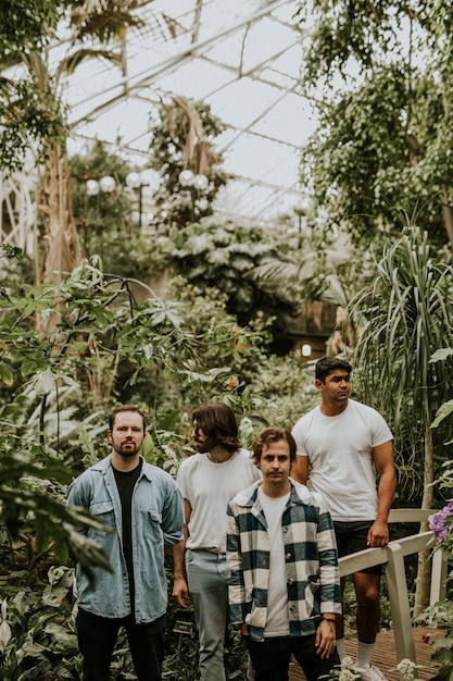 Free photo men posing in garden, botanical greenhouse photoshoot