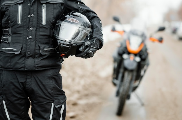 Free photo men riding motorcycle on winter day