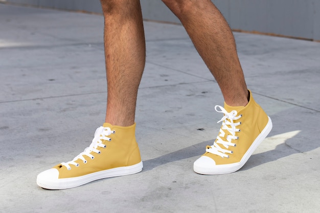 Free Photo men's ankle sneakers yellow street style apparel shoot