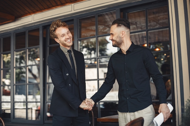 Free Photo men shake hands. enclosure of a business agreement. understanding between business partners.