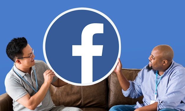 Free Photo men showing a facebook icon