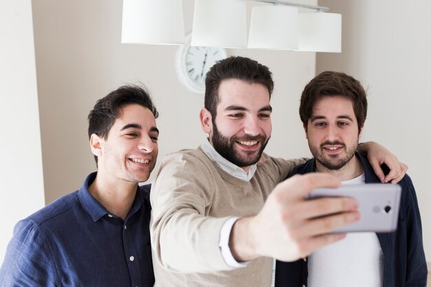 Men taking selfie in office