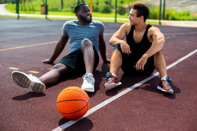 Men talking on the basketball court