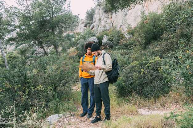 Free photo men trekking in nature