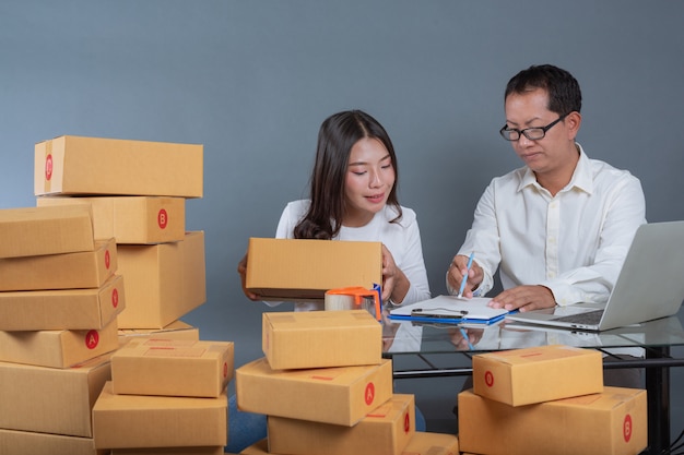 Men and women are helping to pack the boxes.