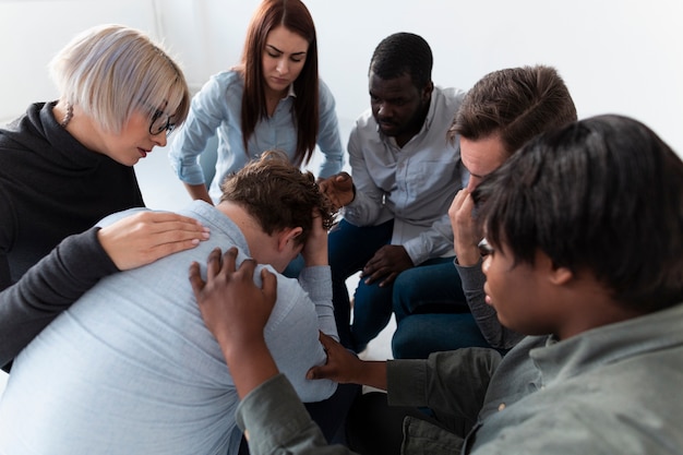 Free photo men and women consoling a sad patient