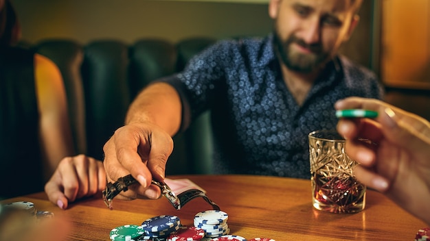 Men and women playing card game. Poker, evening entertainment and excitement concept