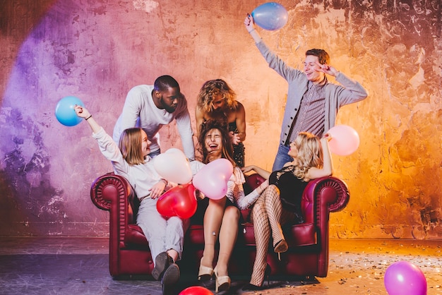 Free photo men and women playing with balloons