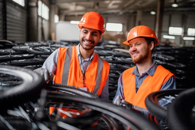 Free photo men working next to a bunch of wheels