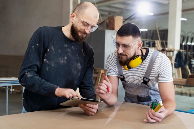 Free photo men working on cutting mdf board