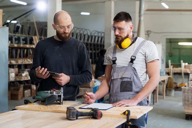 Free Photo men working on cutting mdf board