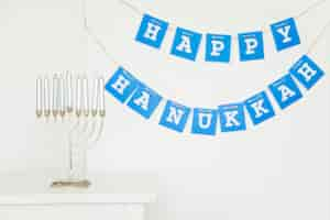 Free photo menorah near happy hanukkah garland