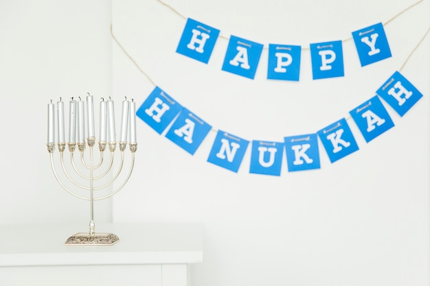 Free Photo menorah near happy hanukkah garland