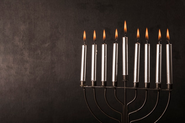 Free Photo menorah with candles near gray wall