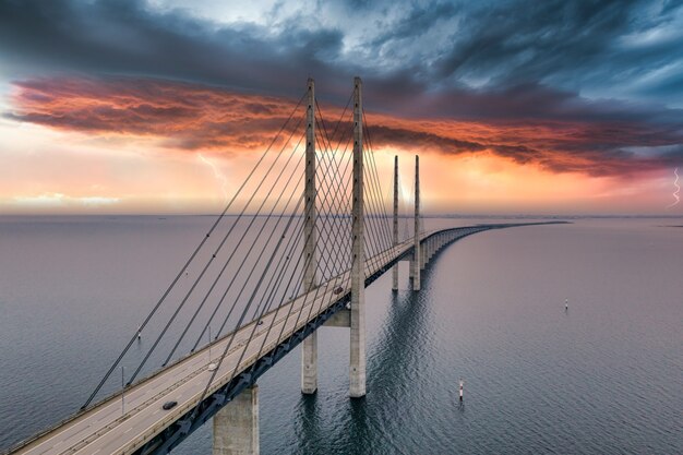 Mesmerizing aerial view of the bridge between Denmark and Sweden under the cloudy sky