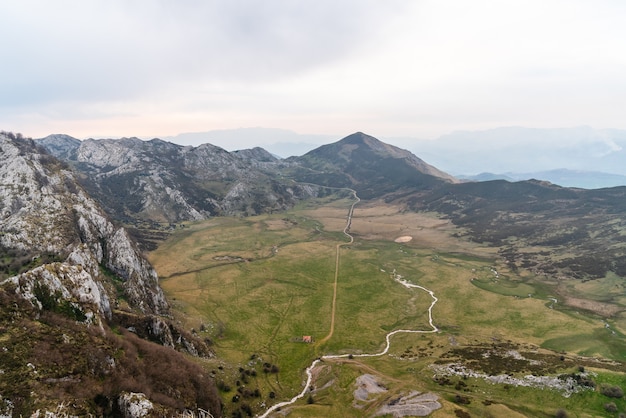 Mesmerizing aerial view of the fields surrounded by rocky mountains