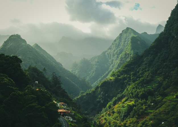 Mesmerizing scenery of green mountains with cloudy sky surface