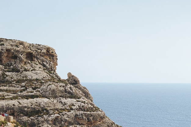 Mesmerizing scenery of a rock formation at the ocean shore in Malta