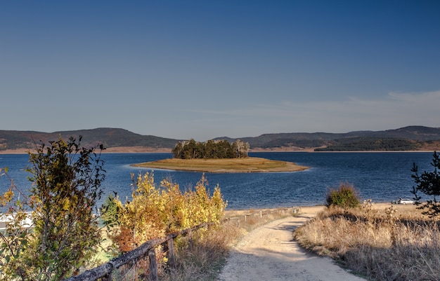 Free photo mesmerizing shot of a calm lake surrounded by greenery in bulgaria