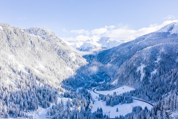 Mesmerizing shot of snow-covered mountains in winter under a blue sky