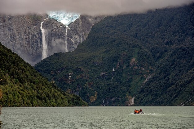 Mesmerizing view of the calm ocean and the rocky mountains with a waterfall