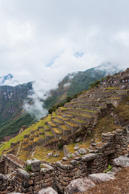 Free photo mesmerizing view of machu picchu in peru covered in clouds