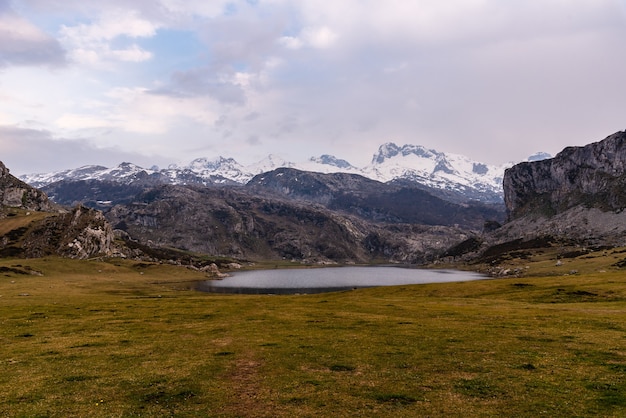 Mesmerizing view of the mountains and rocks reflecting in the water in the field