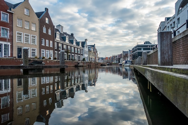 Free Photo mesmerizing view of the reflection of the buildings in the river on a cloudy day