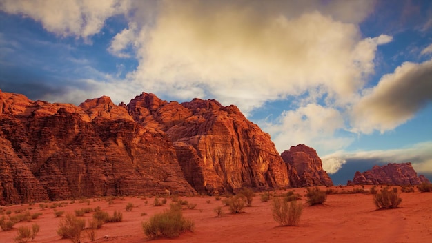 Mesmerizing view of the sandy rocky cliffs under the cloudy blue sky in the desert