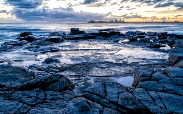 Mesmerizing view of the sunset over rocky seashore in Kap Geinitzort in Rostock, Germany