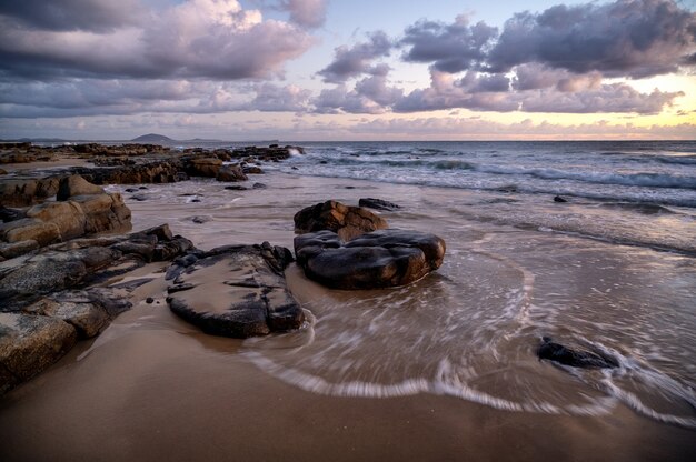 Free photo mesmerizing view of the sunset over rocky seashore in kap geinitzort in rostock, germany