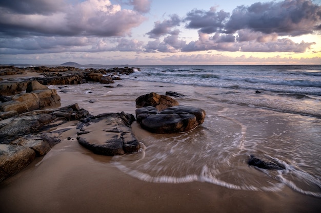 Free Photo mesmerizing view of the sunset over rocky seashore in kap geinitzort in rostock, germany