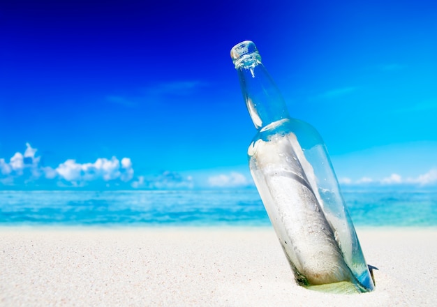 Message in a bottle on beach.