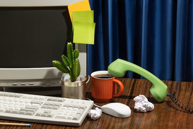 Messy office desk with old computer still life