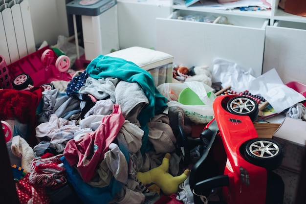 Free photo messy room and disorder concept in the living room or bedroom. scattered clothes and stuff on the floor.