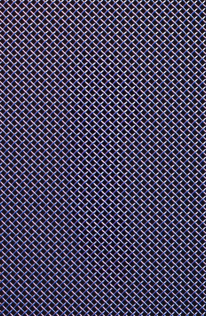 Metal grill closeup texture of a music speaker in colored lighting