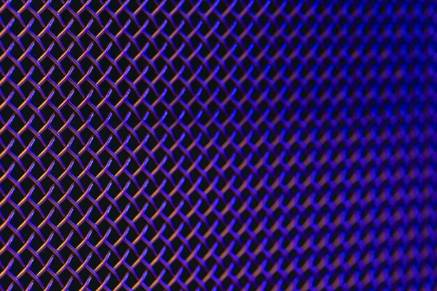 Metal grill closeup texture of a music speaker in colored lighting