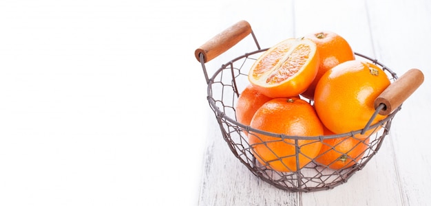 Metallic basket with oranges