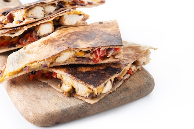 Free photo mexican chicken quesadillas with cheese and peppers isolated on white background