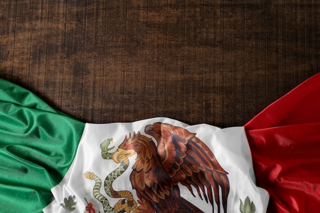 Free photo mexican flag with eagle on floor above view