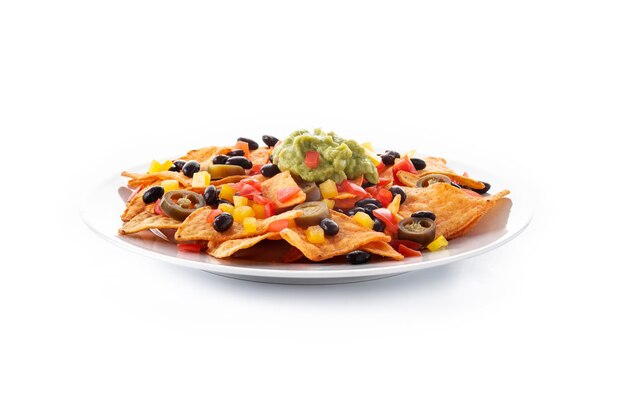 Mexican nachos tortilla chips with black beans, guacamole, tomato and jalapeno isolated on white background