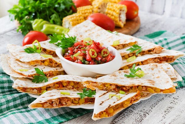 Mexican Quesadilla wrap with chicken, corn and sweet pepper and salsa