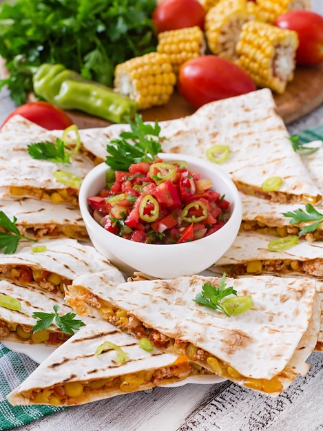 Mexican Quesadilla wrap with chicken, corn and sweet pepper and salsa