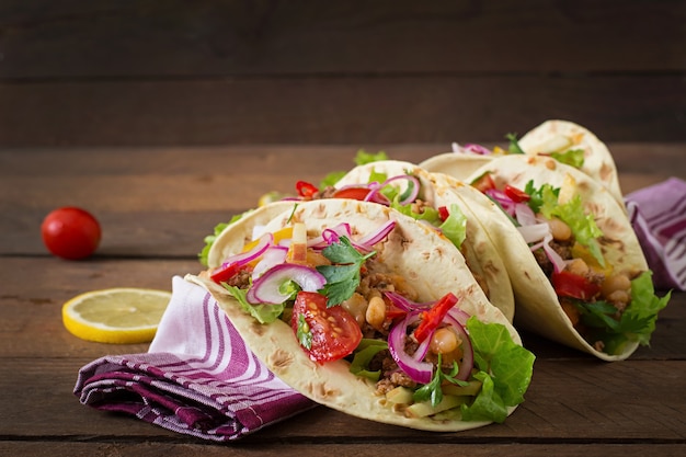 Mexican tacos with meat, beans and salsa