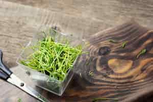 Free photo microgreens. lentil sprouts on a wooden background.