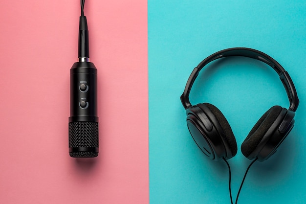 Free photo microphone and headphones on pink and blue background