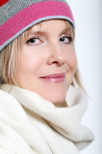 Mid age Woman With Hot tea Wearing Winter Clothes on a white background