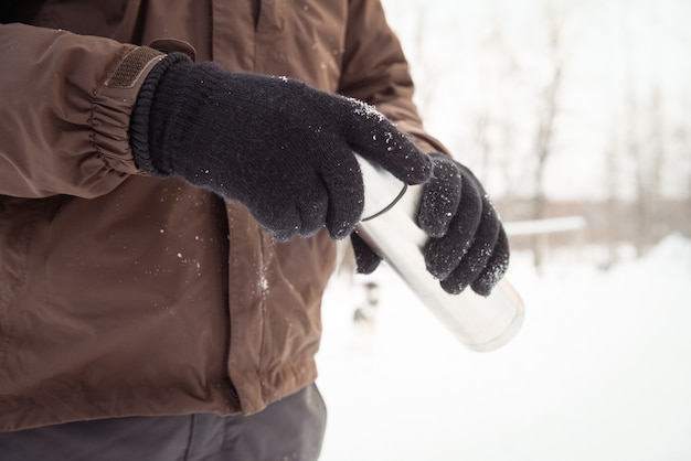 Free Photo mid-section of musher holding thermos