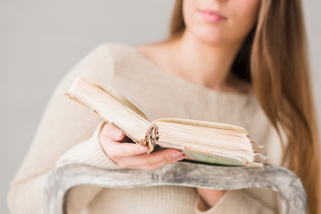 Free Photo mid section of woman holding an open book in hand