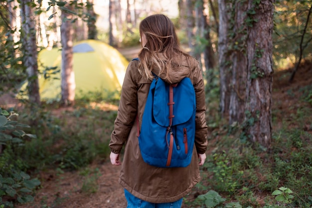 Free Photo mid shot brown haired girl walking to tent